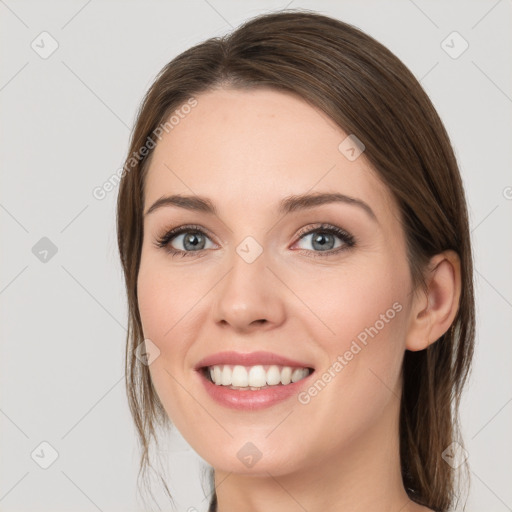 Joyful white young-adult female with long  brown hair and grey eyes