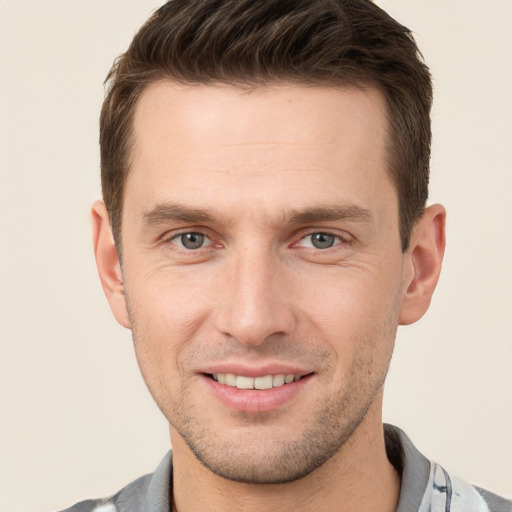 Joyful white young-adult male with short  brown hair and brown eyes