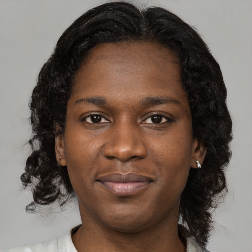 Joyful black young-adult female with medium  brown hair and brown eyes