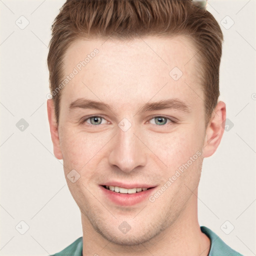 Joyful white young-adult male with short  brown hair and grey eyes