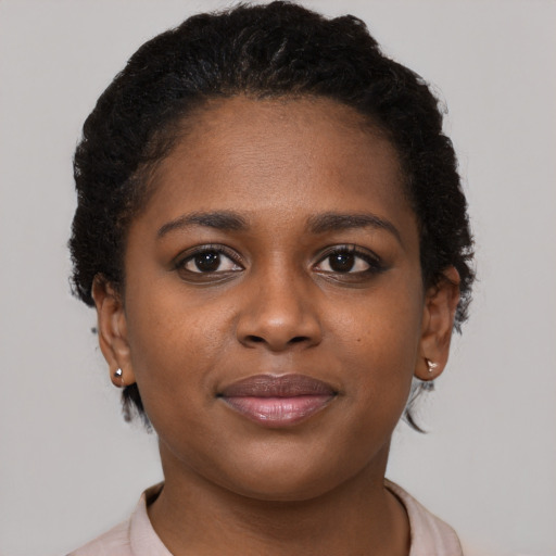 Joyful black young-adult female with short  brown hair and brown eyes