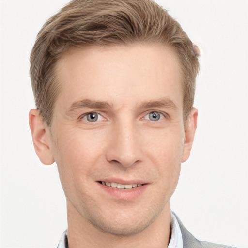 Joyful white young-adult male with short  brown hair and grey eyes