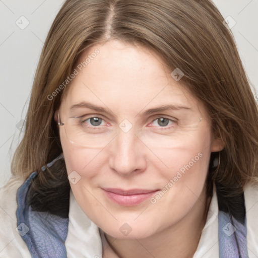 Joyful white adult female with medium  brown hair and blue eyes