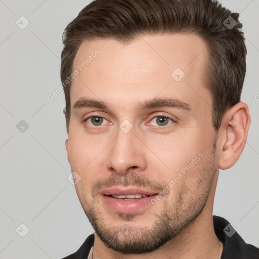 Joyful white young-adult male with short  brown hair and brown eyes