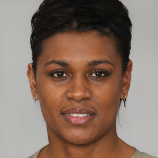 Joyful black young-adult female with short  brown hair and brown eyes