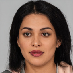 Joyful latino young-adult female with medium  brown hair and brown eyes