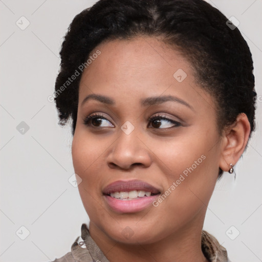 Joyful black young-adult female with short  brown hair and brown eyes