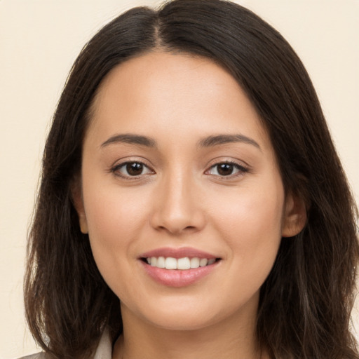 Joyful white young-adult female with long  brown hair and brown eyes