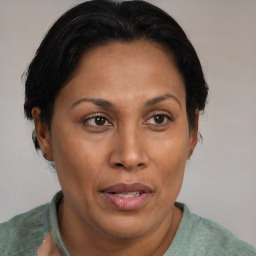 Joyful latino adult female with short  brown hair and brown eyes