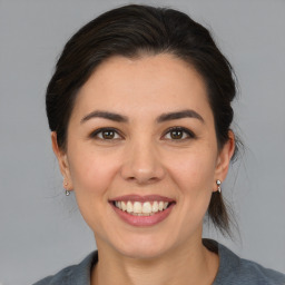 Joyful white young-adult female with medium  brown hair and brown eyes