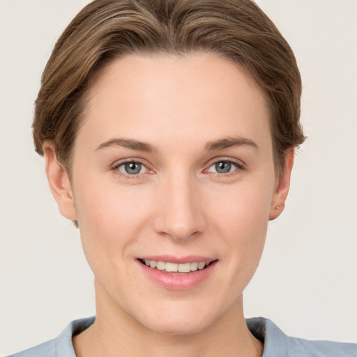 Joyful white young-adult female with short  brown hair and grey eyes