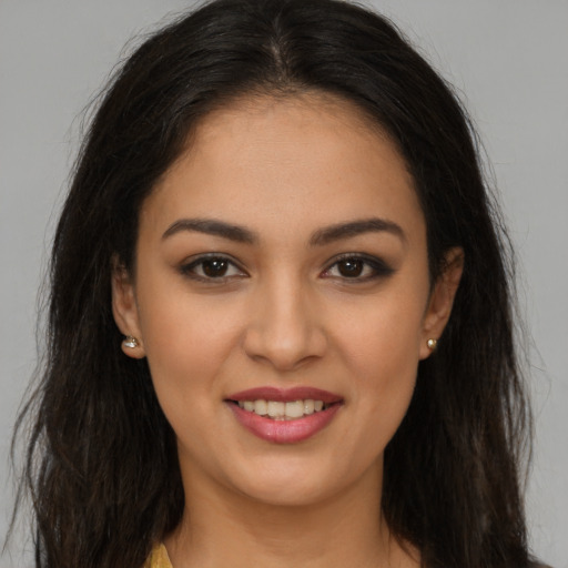 Joyful white young-adult female with long  brown hair and brown eyes