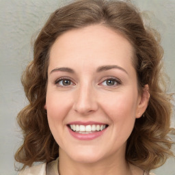 Joyful white young-adult female with medium  brown hair and green eyes