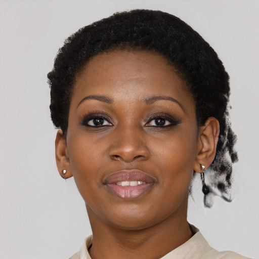 Joyful black young-adult female with short  black hair and brown eyes