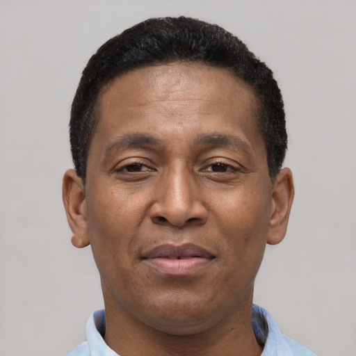 Joyful latino adult male with short  brown hair and brown eyes