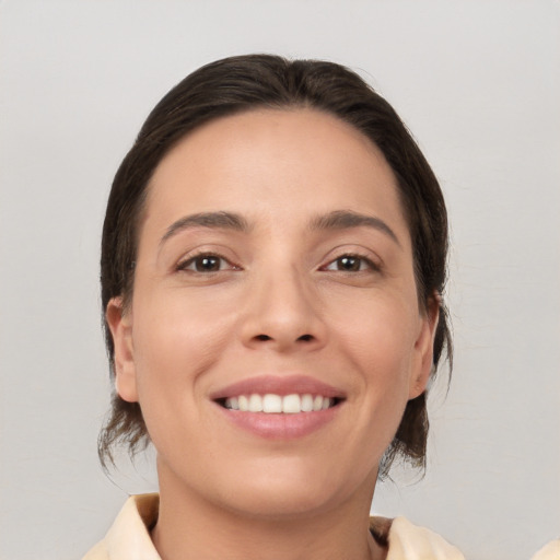 Joyful white young-adult female with medium  brown hair and brown eyes