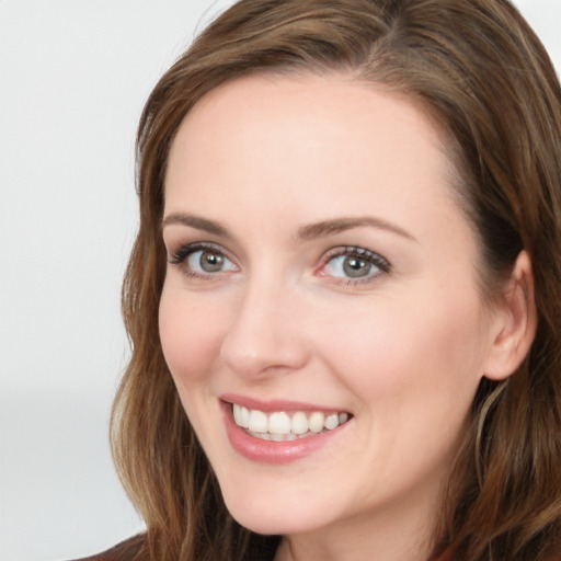 Joyful white young-adult female with long  brown hair and blue eyes