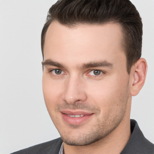 Joyful white young-adult male with short  brown hair and brown eyes