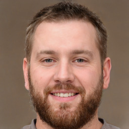 Joyful white adult male with short  brown hair and brown eyes