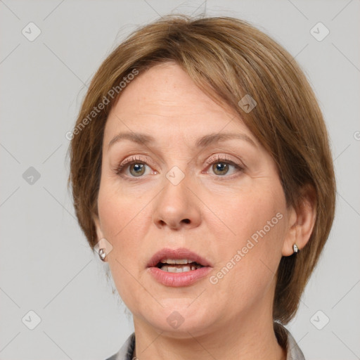 Joyful white adult female with medium  brown hair and grey eyes