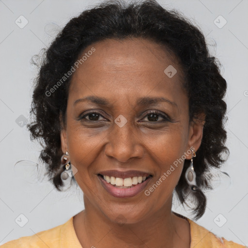 Joyful black adult female with medium  brown hair and brown eyes