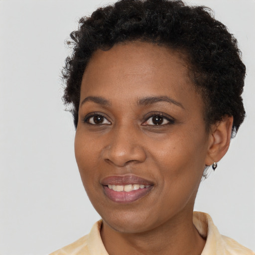 Joyful black young-adult female with short  brown hair and brown eyes