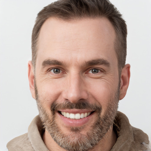 Joyful white adult male with short  brown hair and brown eyes