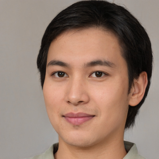 Joyful white young-adult male with medium  black hair and brown eyes