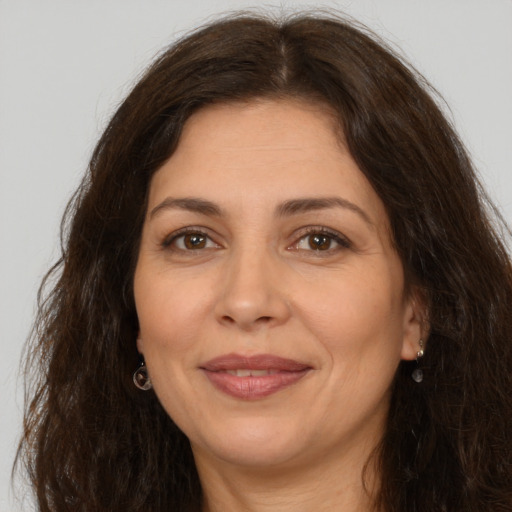 Joyful white adult female with long  brown hair and brown eyes