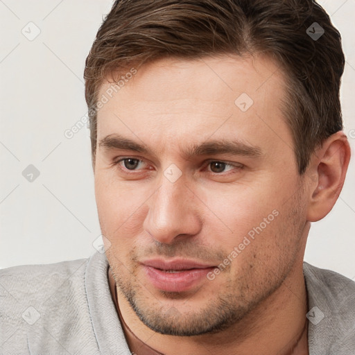 Joyful white young-adult male with short  brown hair and brown eyes