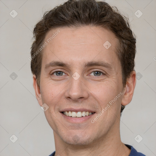 Joyful white adult male with short  brown hair and grey eyes