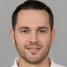 Joyful white young-adult male with short  brown hair and brown eyes