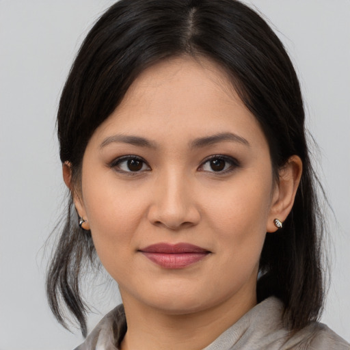 Joyful asian young-adult female with medium  brown hair and brown eyes