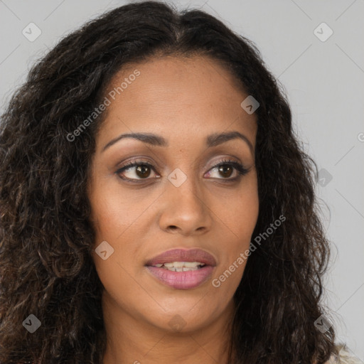 Joyful black young-adult female with long  brown hair and brown eyes