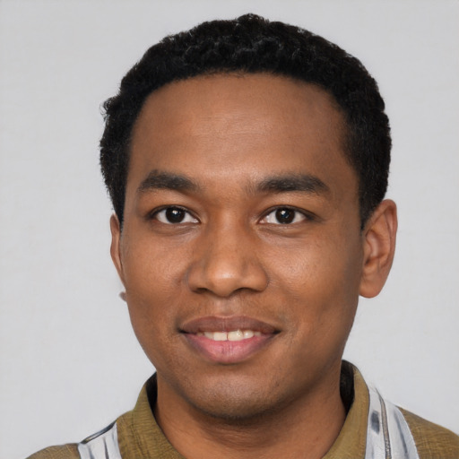 Joyful black young-adult male with short  black hair and brown eyes