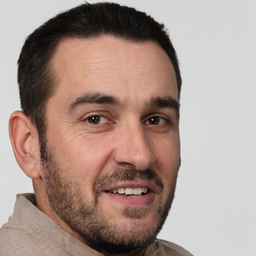 Joyful white adult male with short  brown hair and brown eyes