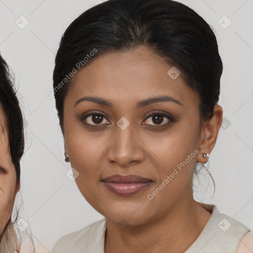 Joyful black young-adult female with medium  brown hair and brown eyes