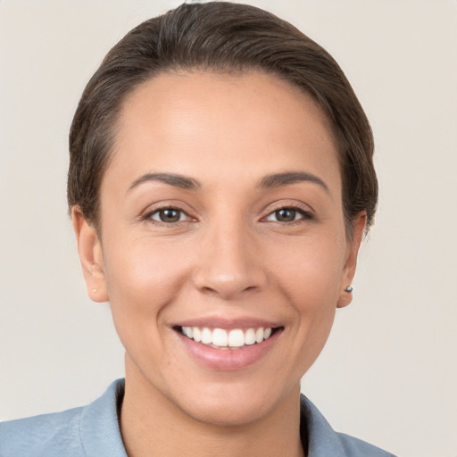 Joyful white young-adult female with short  brown hair and brown eyes