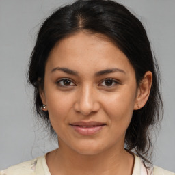 Joyful latino young-adult female with medium  brown hair and brown eyes