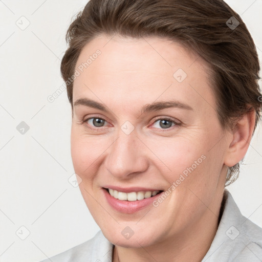 Joyful white young-adult female with short  brown hair and grey eyes