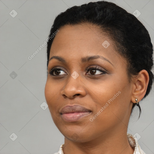 Joyful black young-adult female with short  black hair and brown eyes