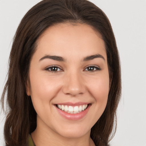 Joyful white young-adult female with long  brown hair and brown eyes