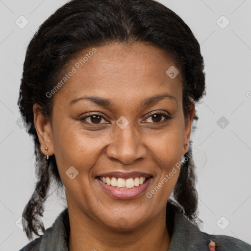 Joyful latino adult female with medium  brown hair and brown eyes