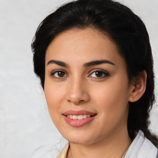 Joyful latino young-adult female with medium  brown hair and brown eyes