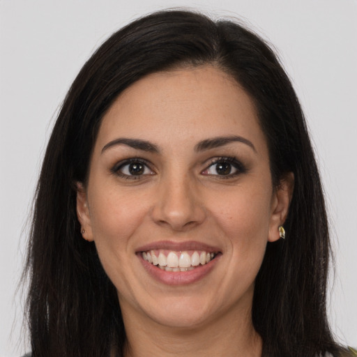 Joyful latino young-adult female with long  brown hair and brown eyes