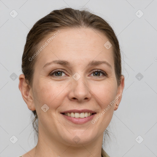 Joyful white adult female with medium  brown hair and grey eyes