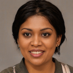 Joyful black young-adult female with medium  brown hair and brown eyes