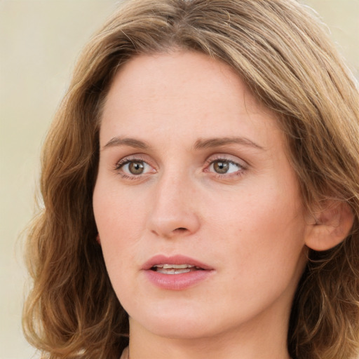 Joyful white young-adult female with long  brown hair and green eyes