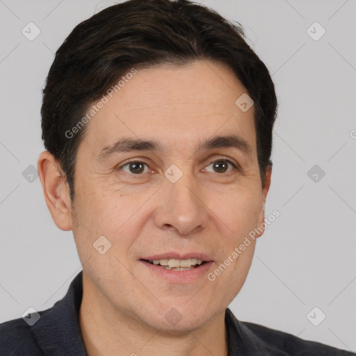 Joyful white adult male with short  black hair and brown eyes