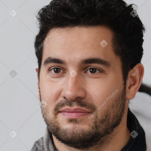 Joyful white young-adult male with short  black hair and brown eyes